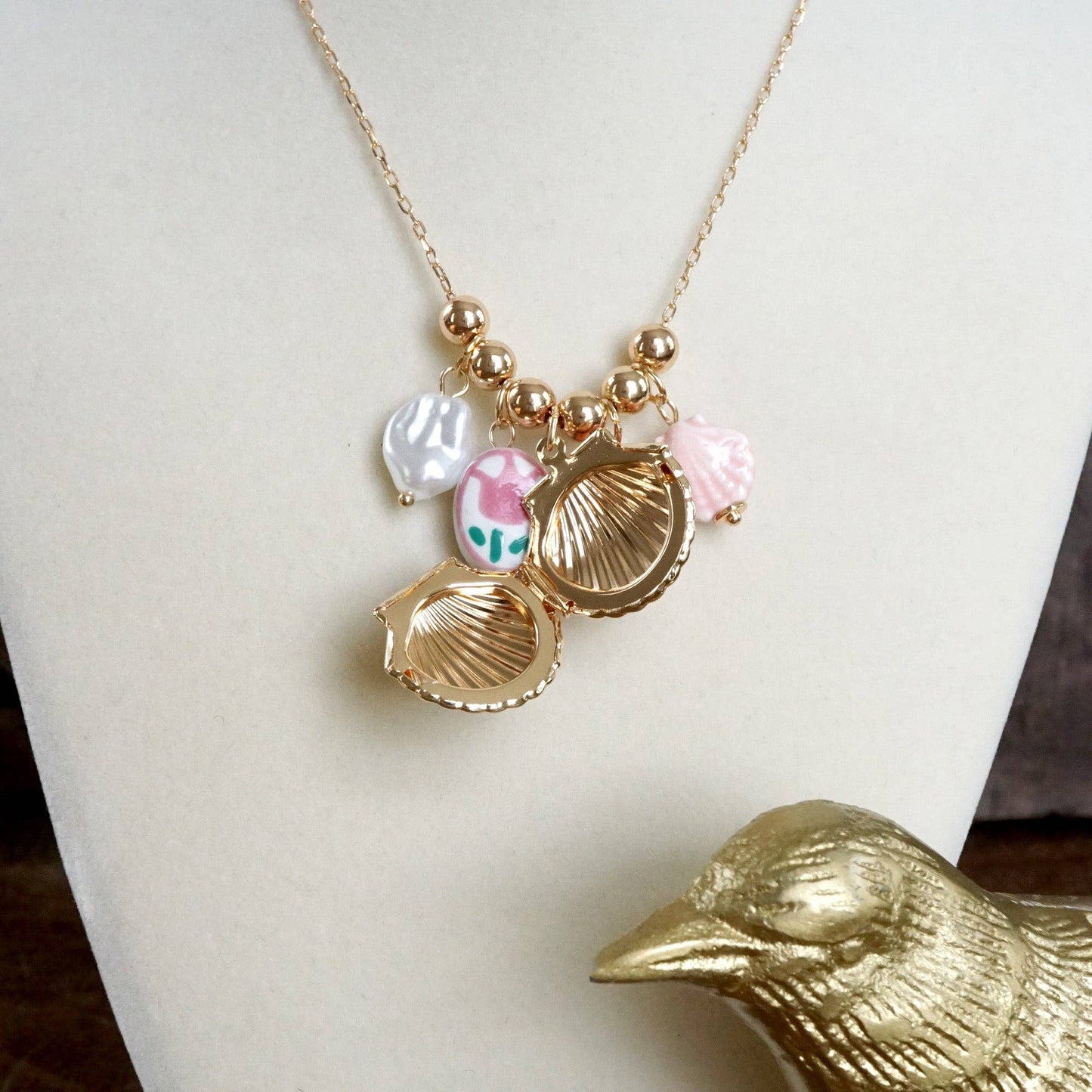 Chinosery multi charm and shell Lockett spring necklace pink and gold