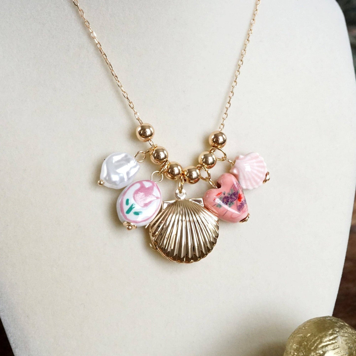 Chinosery multi charm and shell Lockett spring necklace pink and gold